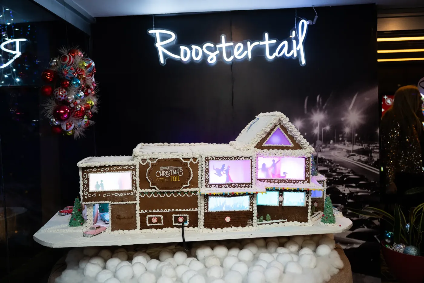 Gingerbread Roostertail under the neon script